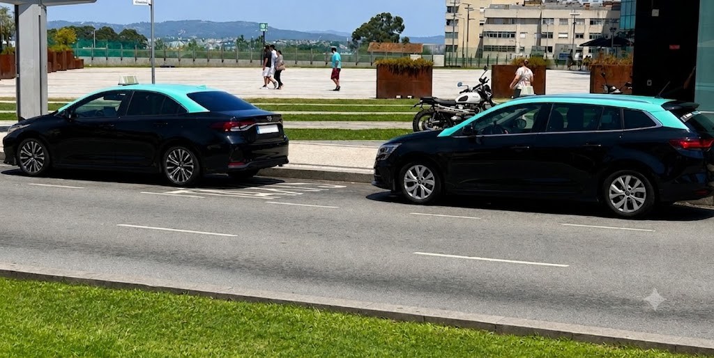 Two teal-roofed taxis parked at a taxi rank in Porto, with pedestrians and a motorcycle in the background
